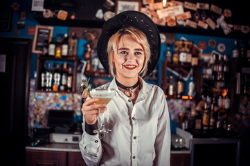 Girl barman concocts a cocktail in the pothouse