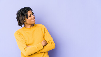 Young black man wearing rasta hairstyle dreaming of achieving goals and purposes