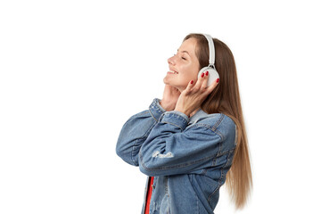 Studio portrait of a charming young woman smiling happily during a photo shoot. Listen to music with headphones.