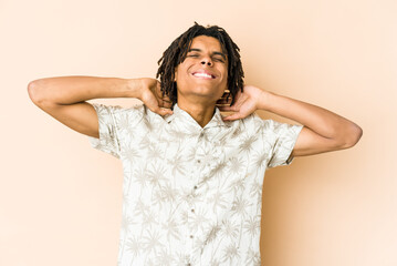 Fototapeta premium Young african american rasta man feeling confident, with hands behind the head.