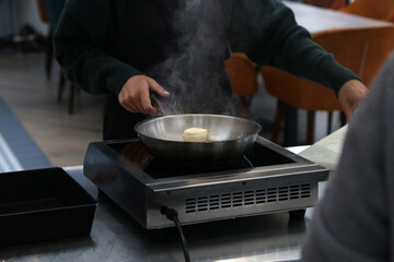 cooking cottage cheese pancakes in a skillet in the kitchen