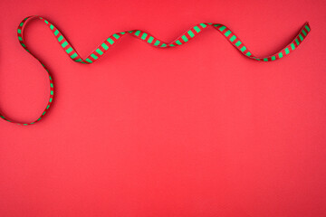 red background with Christmas ribbon.