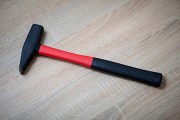Hammer on the wooden table.