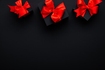 Gifts with red ribbon, present on black background top view. Valentine's day. Birthday. Women's day. Merry Christmas and Happy Holidays greeting card	

