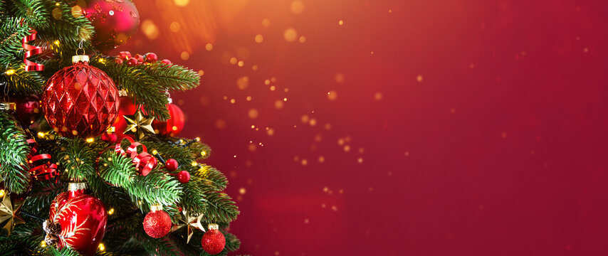 Decorated with ornaments and lights Christmas tree on red background. Merry Christmas and Happy Holidays greeting card, frame, banner. New Year. Noel	
