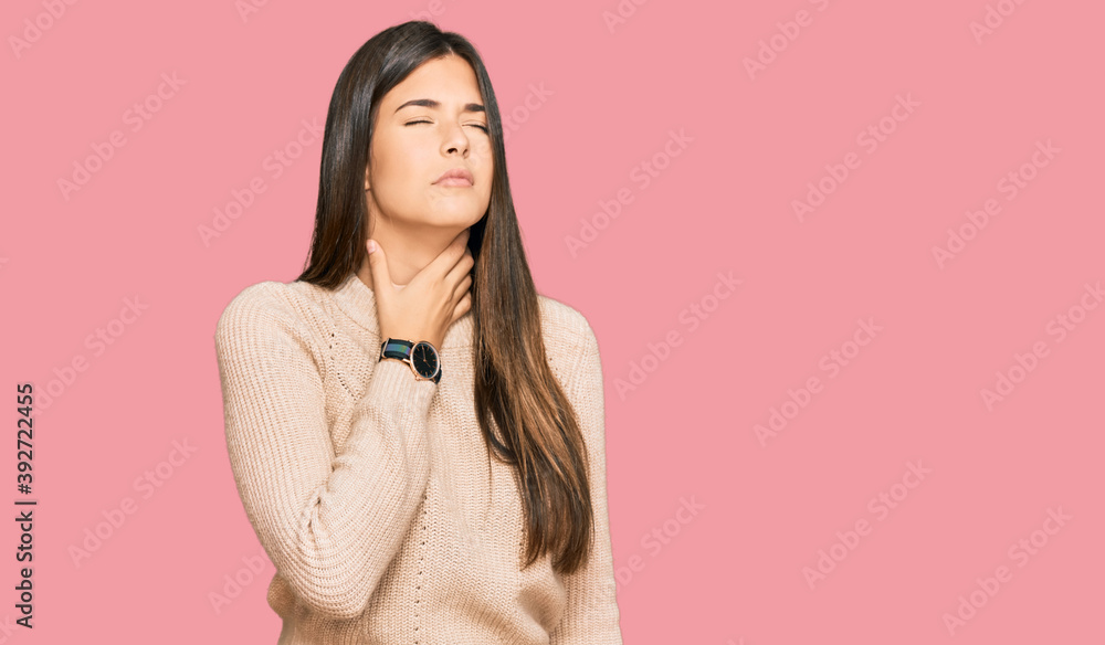 Wall mural Young brunette woman wearing casual winter sweater touching painful neck, sore throat for flu, clod and infection