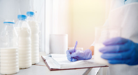 Food expert records test results and laboratory analysis of milk samples