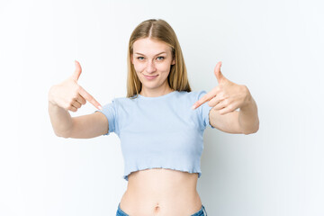 Young blonde woman isolated on white background points down with fingers, positive feeling. © Asier