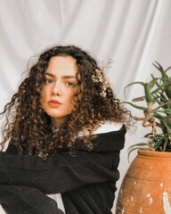 portrait woman with curly brown hair	