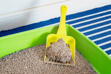 Close up on a cat litter and scoop. Natural clay that forms clumps with urine. Feline urinary tract...