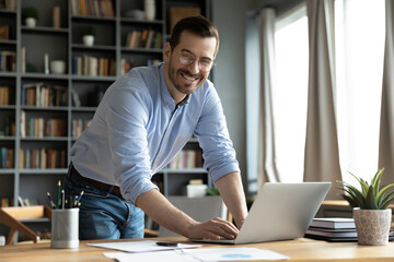 In modern office good-looking businessman young entrepreneur successful business owner standing...