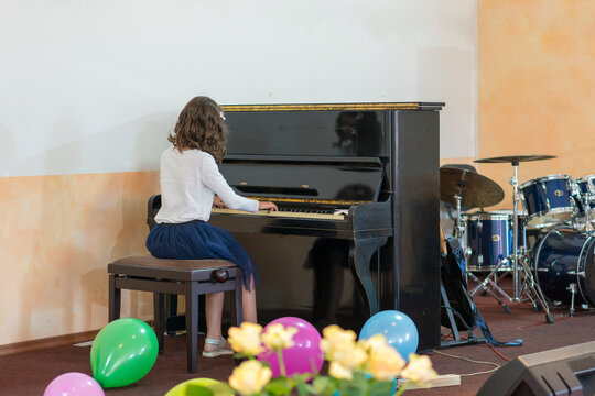 Teenage Girl Playing The Piano On Stage. Selected Focus