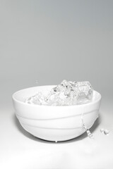 water splashes in a glass with ice on a white background