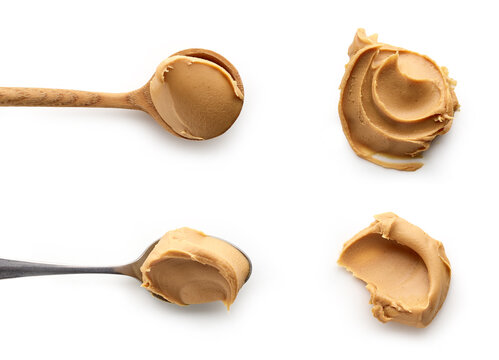 Set of Peanut butter in spoons isolated on white background, top view