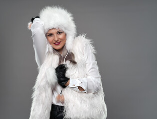 Young woman in white fur coat and hat