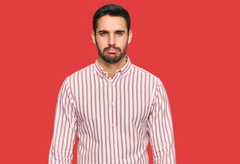 Fototapeta premium Young hispanic man wearing business shirt depressed and worry for distress, crying angry and afraid. sad expression.