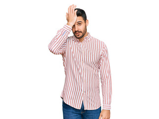 Young hispanic man wearing business shirt surprised with hand on head for mistake, remember error....