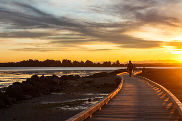 person on walkway at sunset