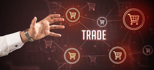 Close-Up of cropped hand pointing at TRADE inscription, online shopping concept