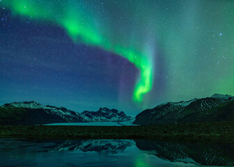 Aurora Borealis Over Icelandic Glacier And Mountains