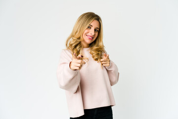 Young caucasian blonde woman pointing to front with fingers.