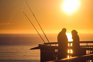Fototapeta na wymiar couple fishing at sunrise