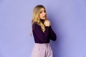 Young caucasian blonde woman scared and afraid.