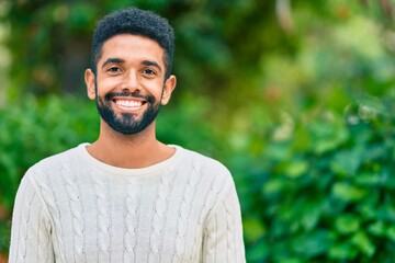 Young african american man smiling happy standing at the park.