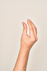 Naklejka premium Hand of caucasian young man showing fingers over isolated white background picking and taking invisible thing, holding object with fingers showing space