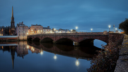 Night view of bridge over the River Ayr and embankment at the Ayr city. Street lamps light. Ayr, Scotland, United Kingdom