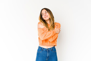 Young caucasian woman isolated on white background hugs, smiling carefree and happy.