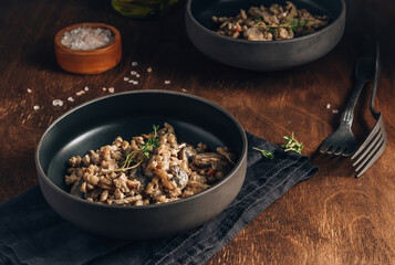 Homemade creamy vegan risotto or orzotto with barley, mushrooms and coconut milk