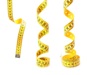 Set of yellow measuring tapes on white background