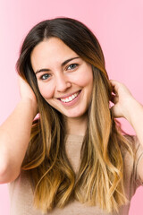 Fototapeta premium Young beautiful woman isolated on pink background