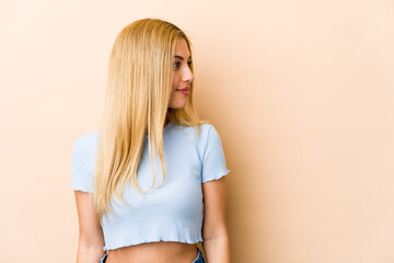 Young blonde caucasian woman gazing left, sideways pose.