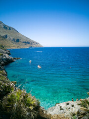 Fototapeta na wymiar Beautiful water of a little beach in Zingaro natural reserve in Sicily, Italy