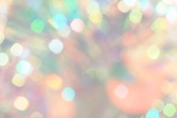 Peach Fuzz color background. Holiday lights bokeh Christmas and New Year, pastel colors.