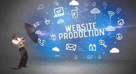 Businessman defending with umbrella from WEBSITE PRODUCTION inscription, modern technology concept