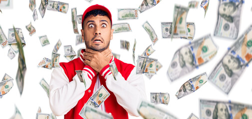 Young hispanic man wearing baseball uniform shouting and suffocate because painful strangle. health problem. asphyxiate and suicide concept.