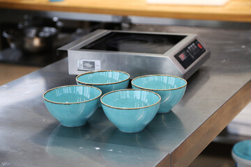 blue plates on metal table in restaurant kitchen