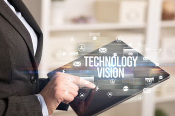 Close-up of a tablet searching TECHNOLOGY VISION inscription, modern technology concept