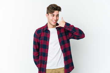 Young caucasian man isolated on white background showing a mobile phone call gesture with fingers.