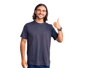 Young handsome man wearing casual clothes smiling happy and positive, thumb up doing excellent and approval sign