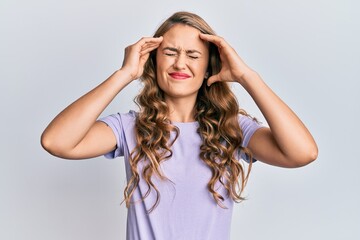Fototapeta premium Young blonde girl wearing casual clothes with hand on head, headache because stress. suffering migraine.