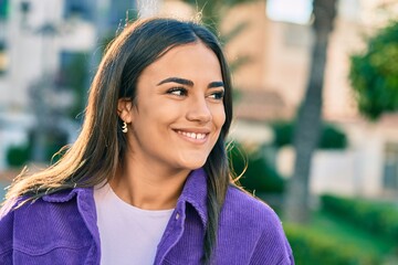 Young hispanic woman smiling happy walking at the city.