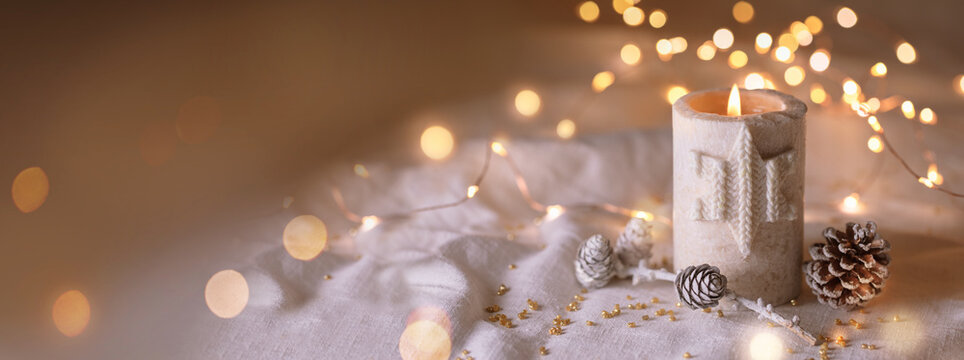 Christmas Candle on white linen with golden lights -  Natural decoration with pine cones and twig - Merry Christmas Card -  Advent Banner, Panorama, Background