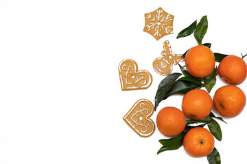 Christmas and new year atmosphere flatlay. Overhead view. Gingerbread cookies, tangerines decorations isolated on white background. Copy space
