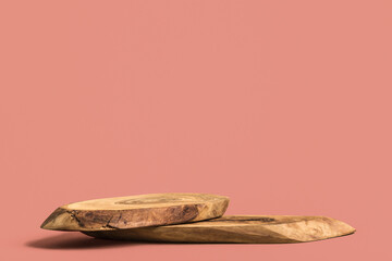 Wooden podium for cosmetic products or perfumes on a pink background. Mockup