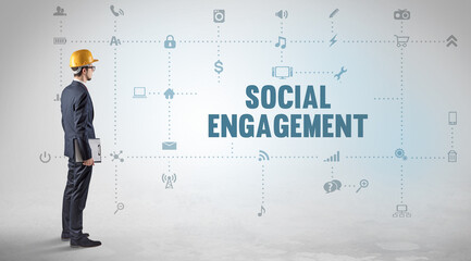Engineer working on a new social media platform with SOCIAL ENGAGEMENT inscription concept