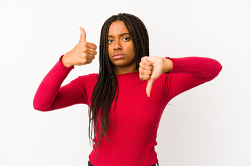 Young african american woman isolated showing thumbs up and thumbs down, difficult choose concept